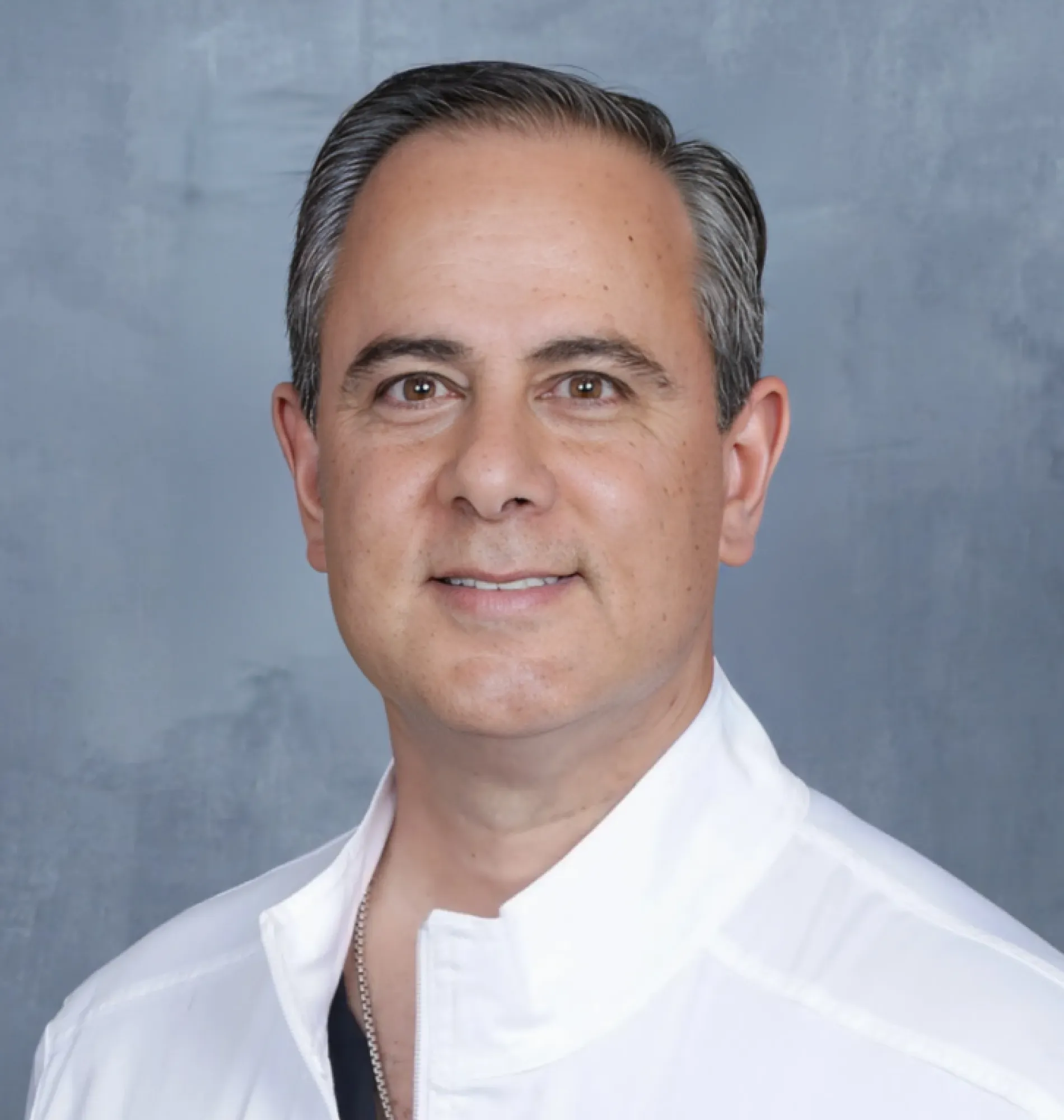 A man wearing a white shirt and black tie.