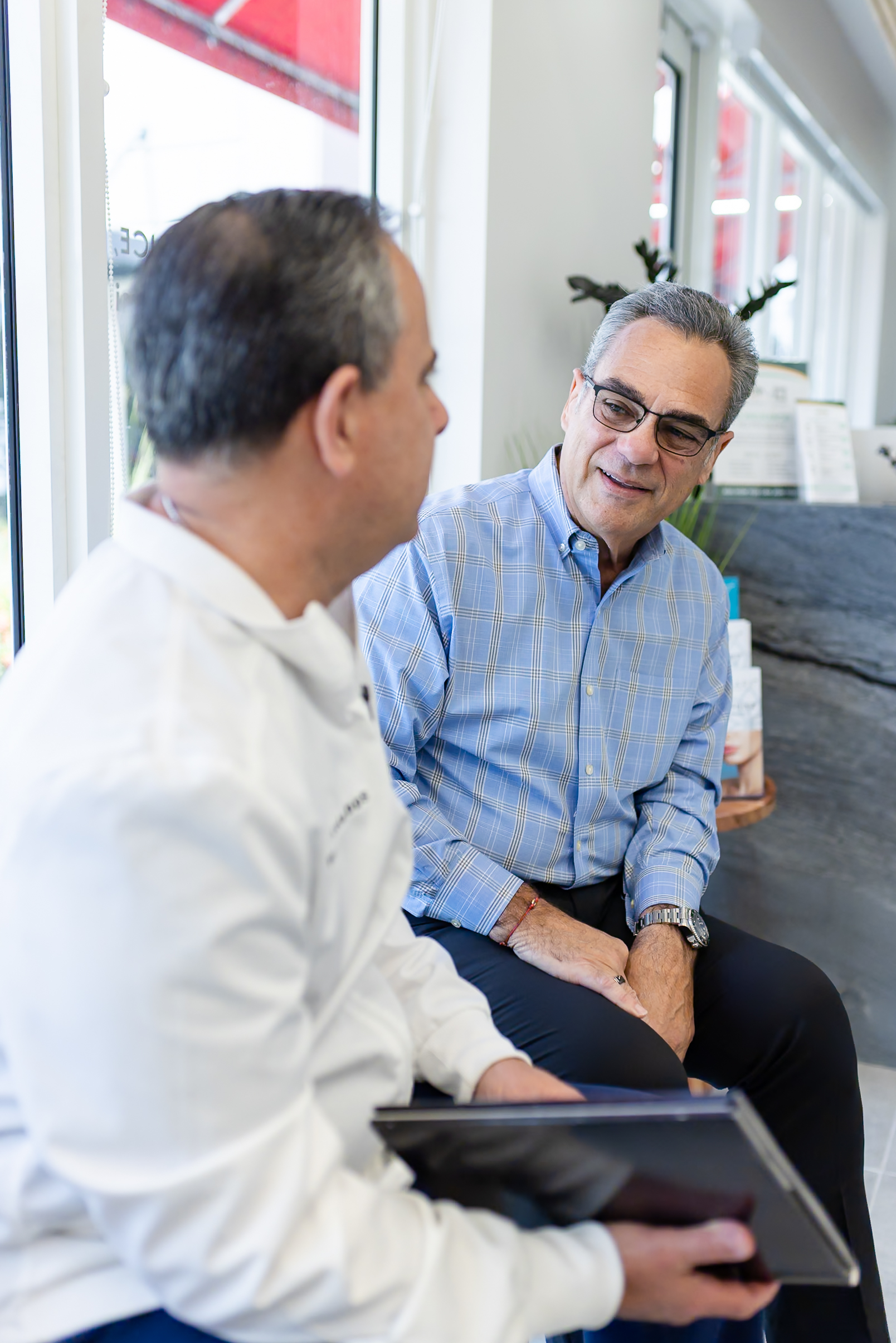 Dentist discussing a digital treatment plan with a patient at Gen2 Dentistry in Davie, Florida.