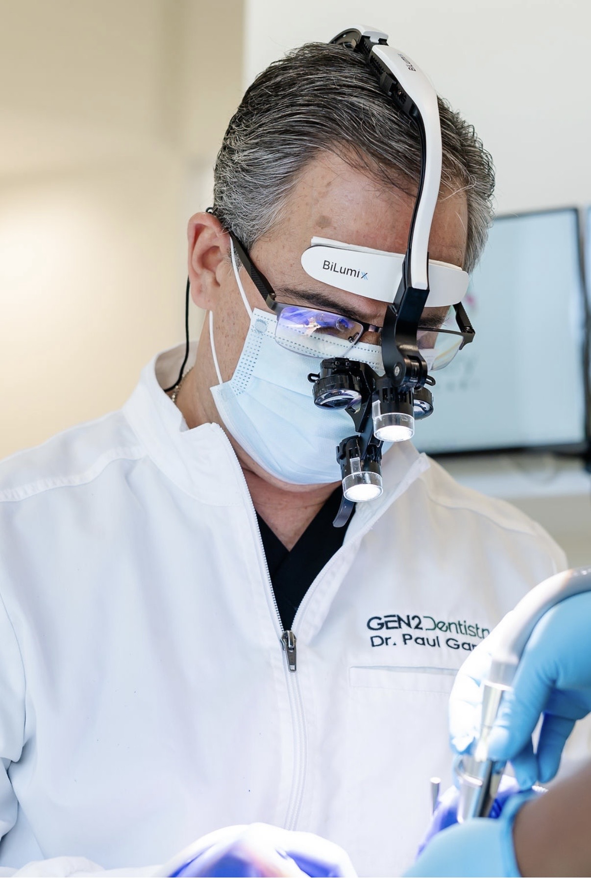 Dr. Garcia performing precision dental treatment with magnification at Gen2 Dentistry in Davie, FL