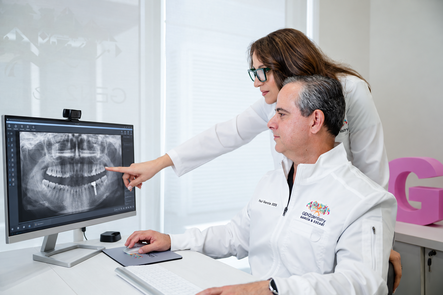 Gen2 Dentistry doctors reviewing a panoramic dental X-ray for treatment planning in Davie, Florida.