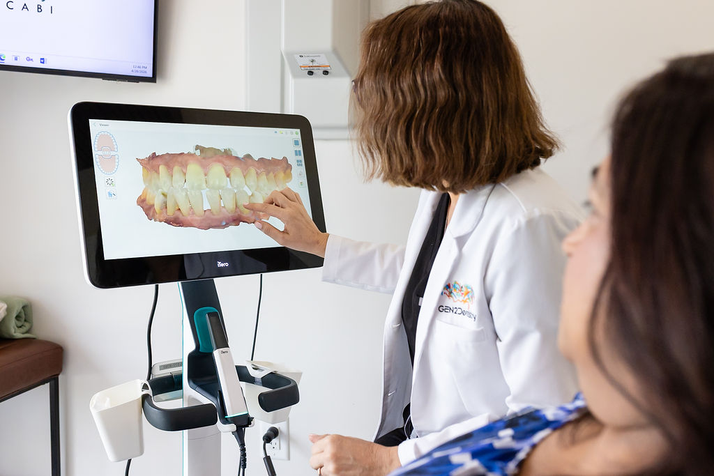 Dr. Maria Escabi reviewing a digital 3D dental scan with a patient at Gen2 Dentistry in Davie, Florida.