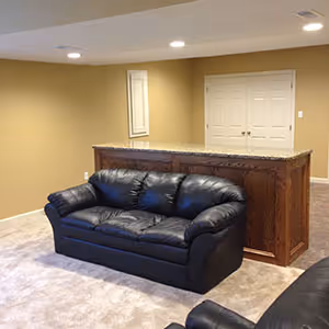 finished basement couch in front of bar