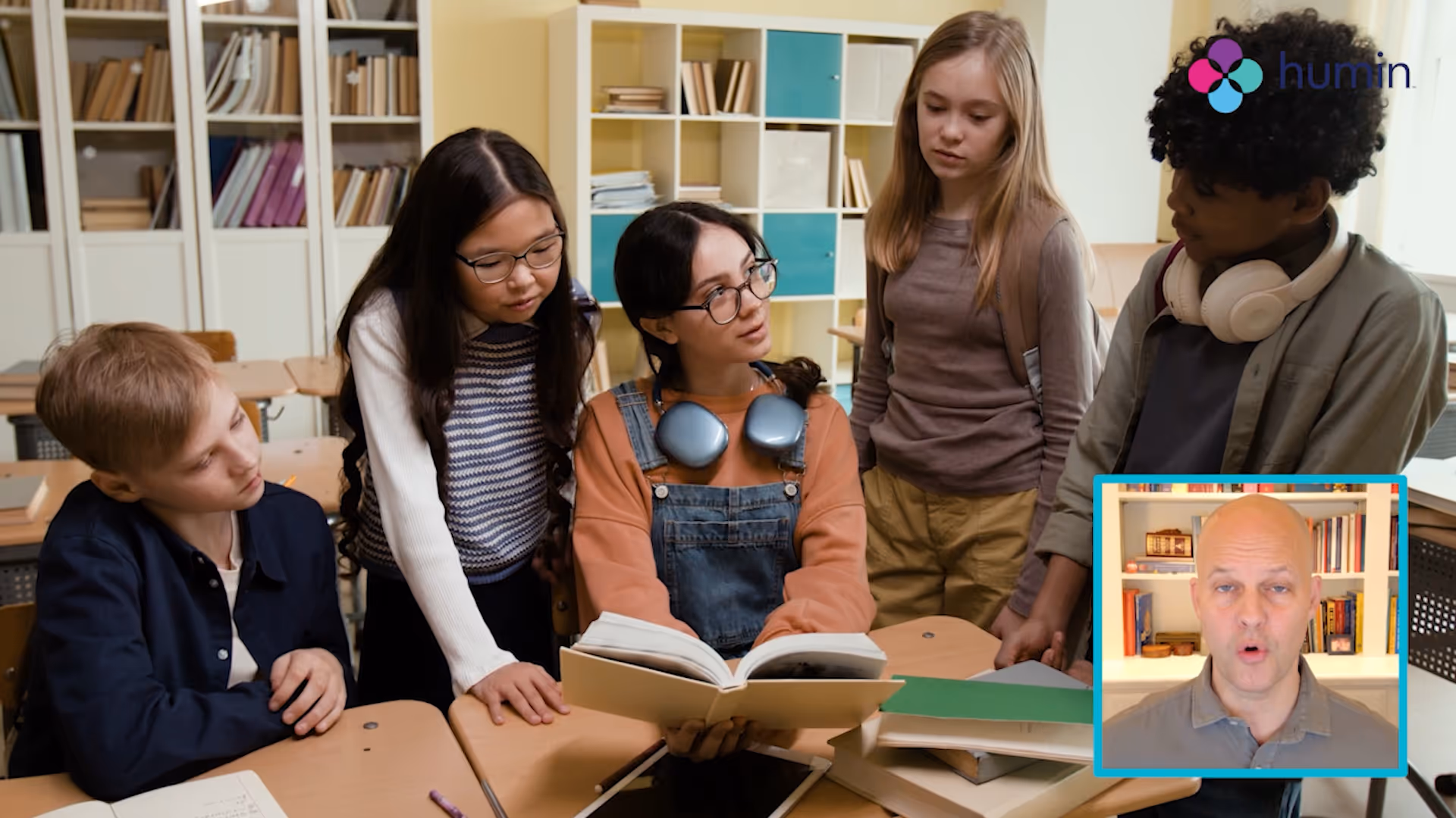 Team of masked colleagues brainstorming with colorful sticky notes on glass wall during a virtual meeting with a man shown in an inset video call window.