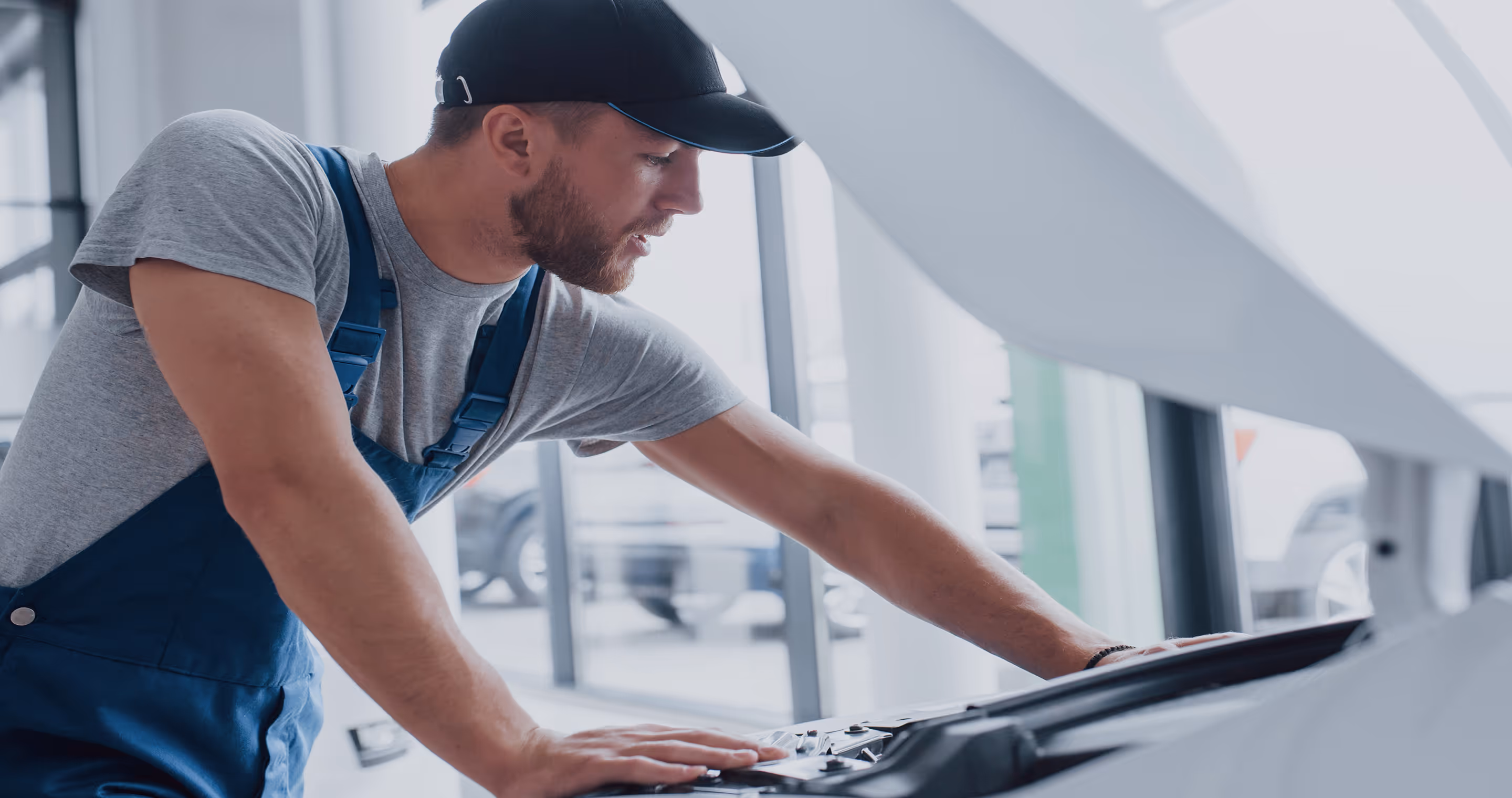 A man working on a car in a garage.