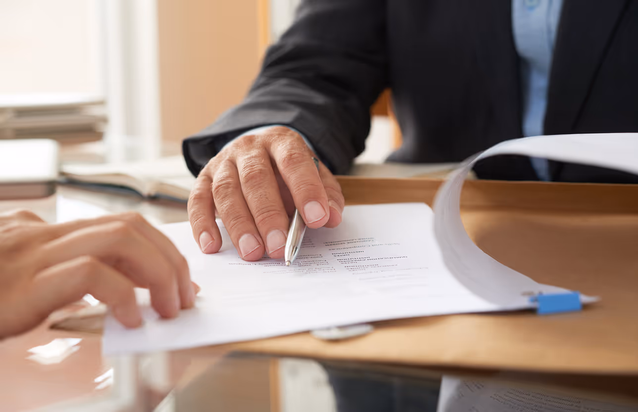 A close up of a person holding a pen and paper.