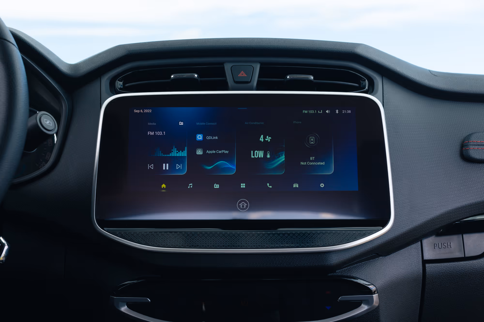 Car dashboard touchscreen displaying media options, mobile connectivity with QDLink and Apple CarPlay, air conditioner settings, and phone Bluetooth status.