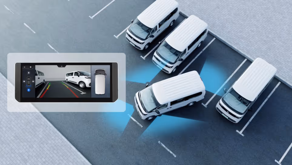 Top-down view of white vans parking with a digital screen showing a rearview camera and parking assist sensors highlighting the van's position.