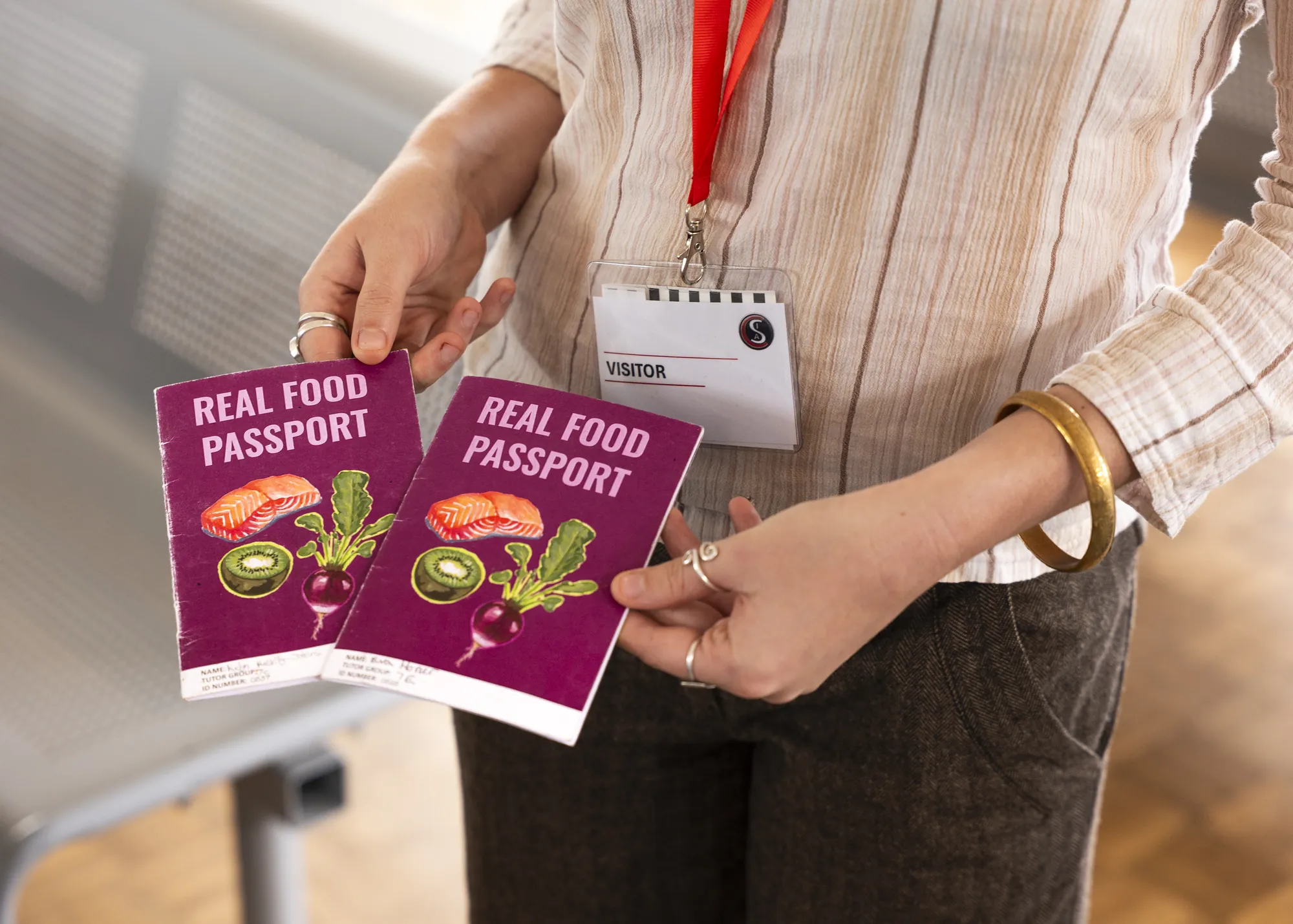Printed passport held by designer