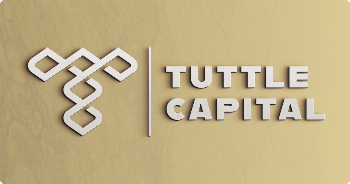 A 3D mockup of the Tuttle Capital logo on a gold marble background.