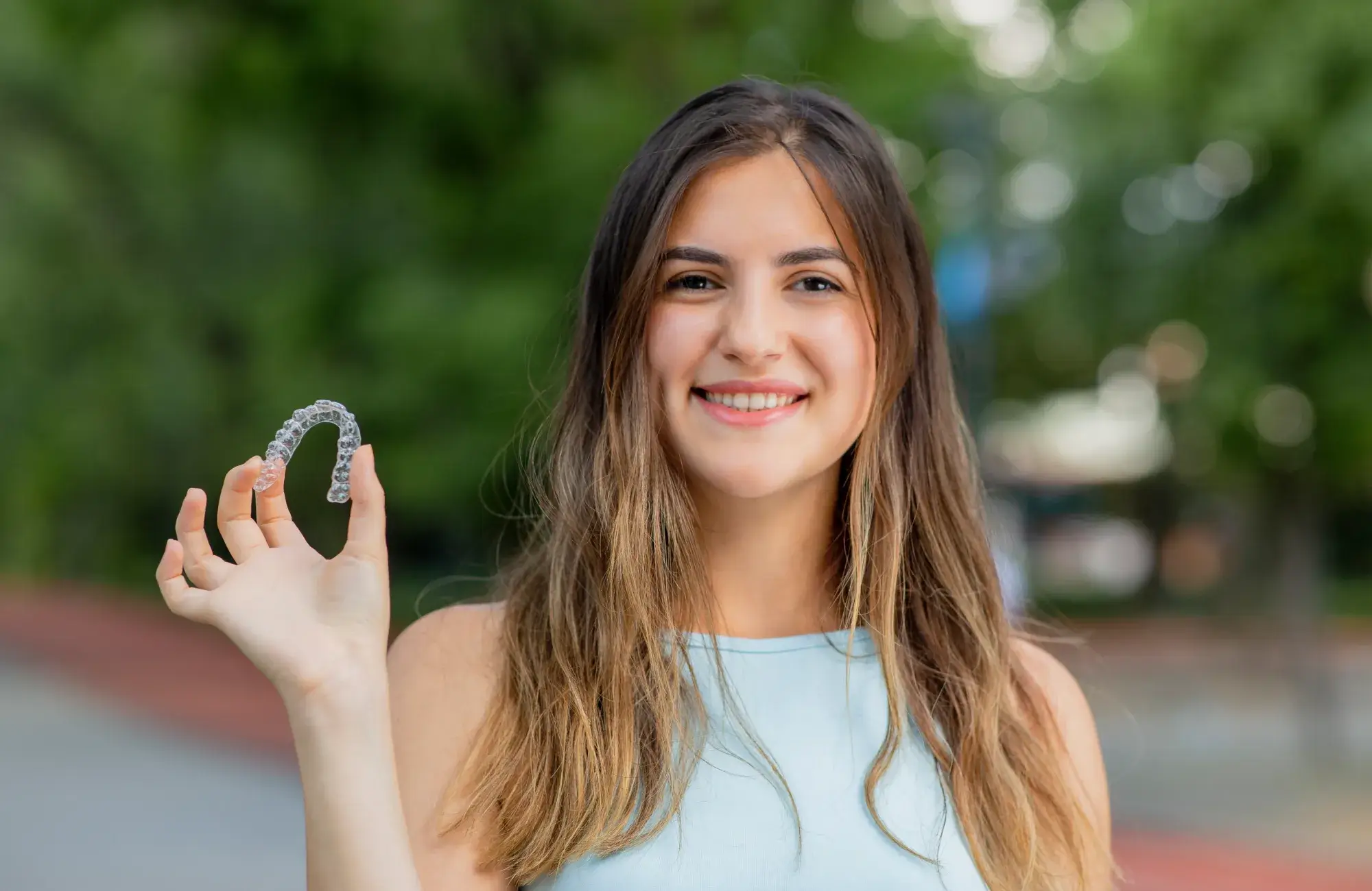 A woman is holding a ring in her hand.
