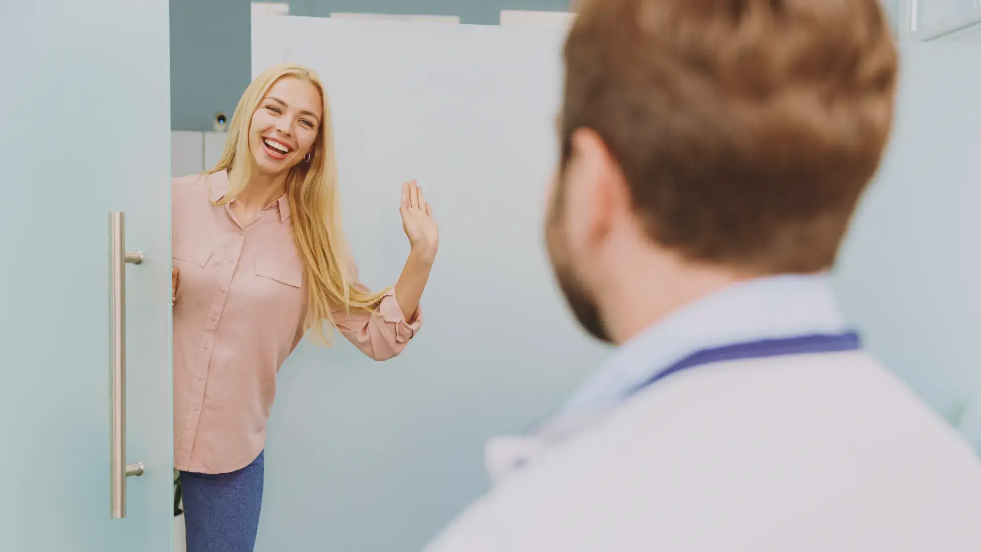 A woman is standing in front of a mirror.