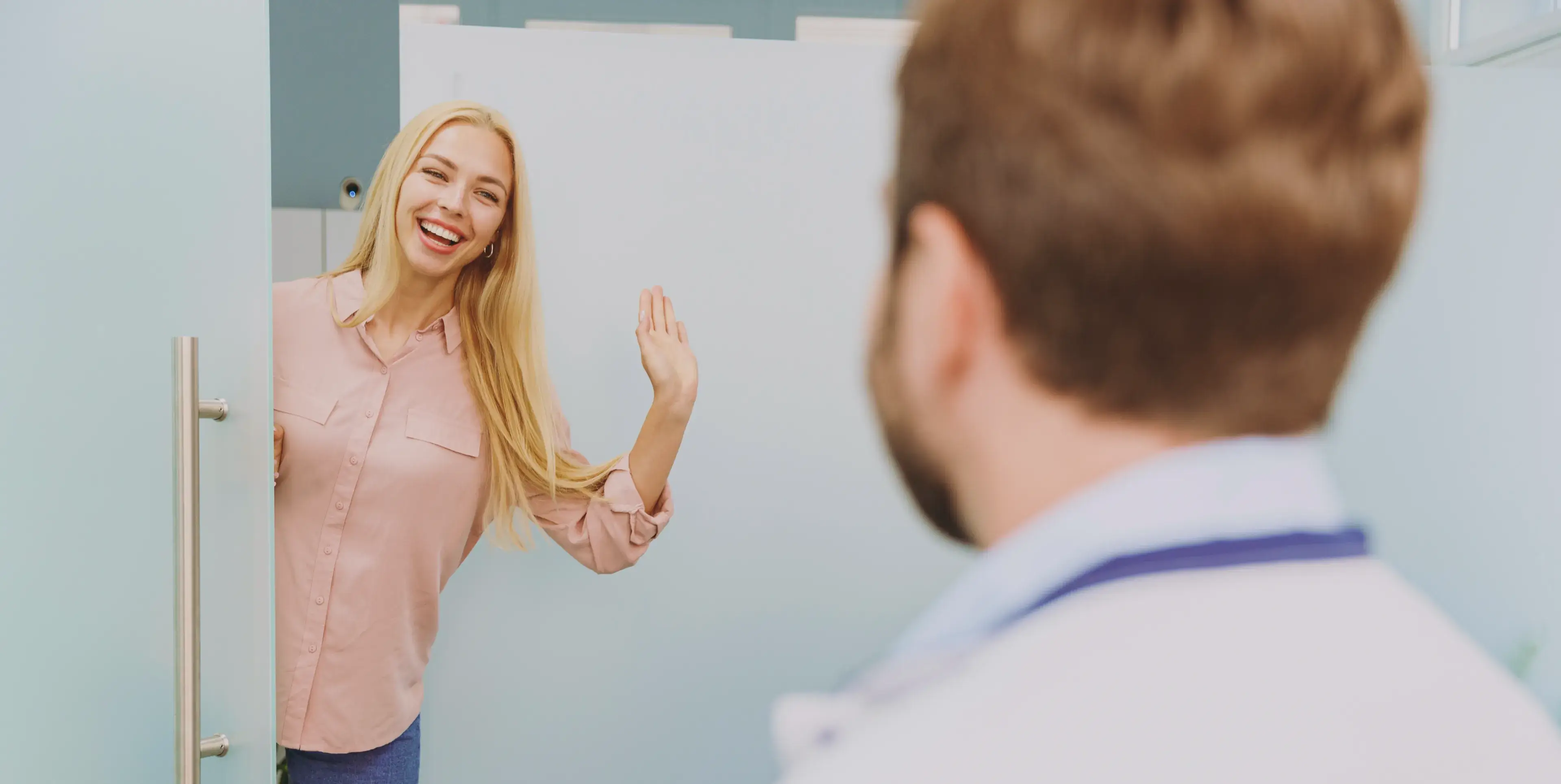 A woman standing in front of a mirror making a face.