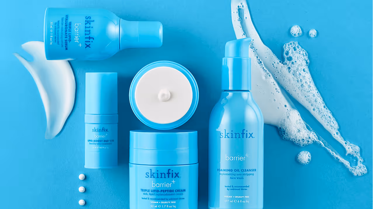Collection of Skinfix Barrier+ skincare products on a blue background with cream and foam textures.