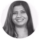 Smiling woman with long dark hair wearing a light-colored top.