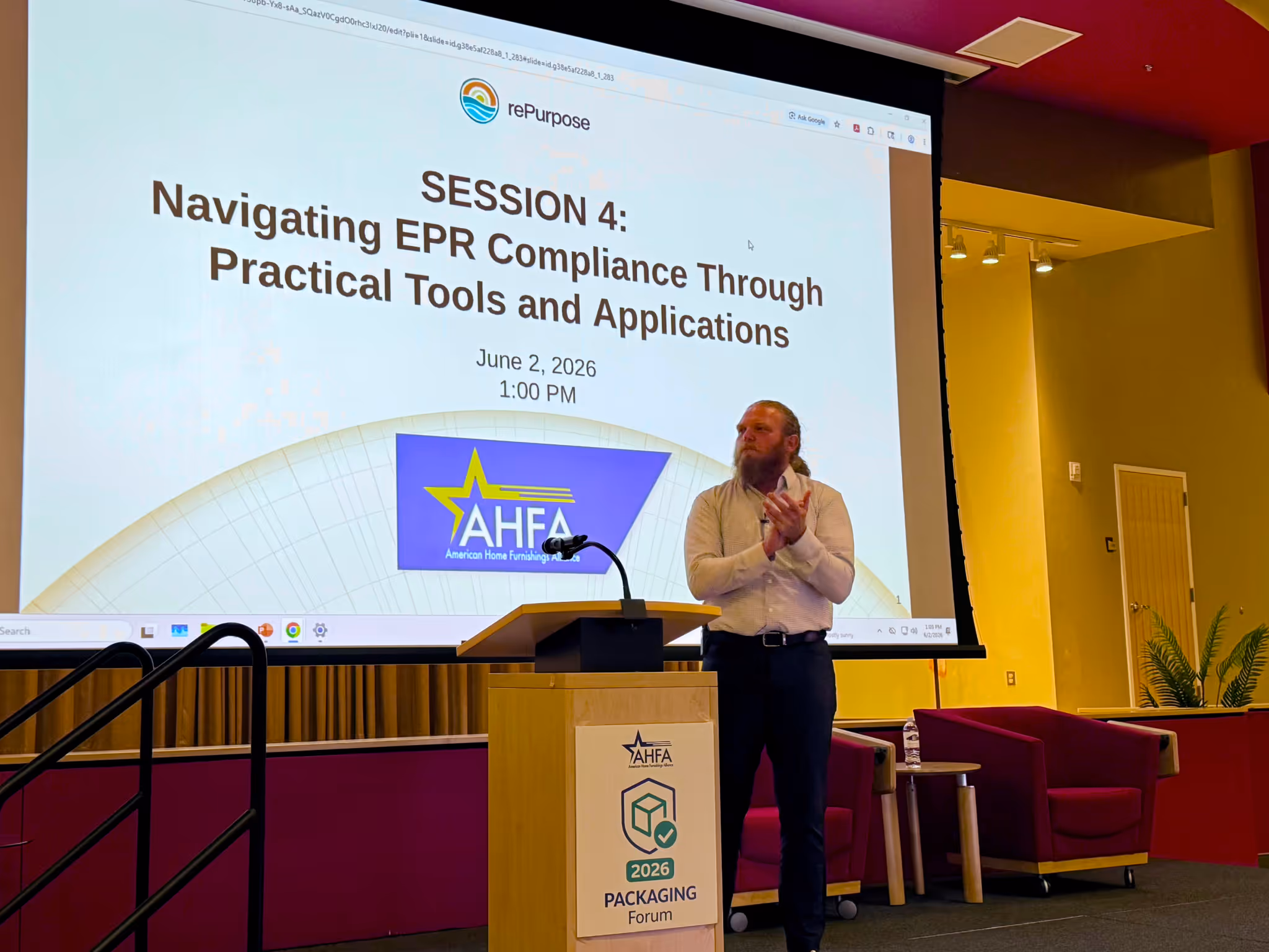 Man clapping beside podium presenting 'Navigating EPR Compliance' session at AHFA Packaging Forum 2026.