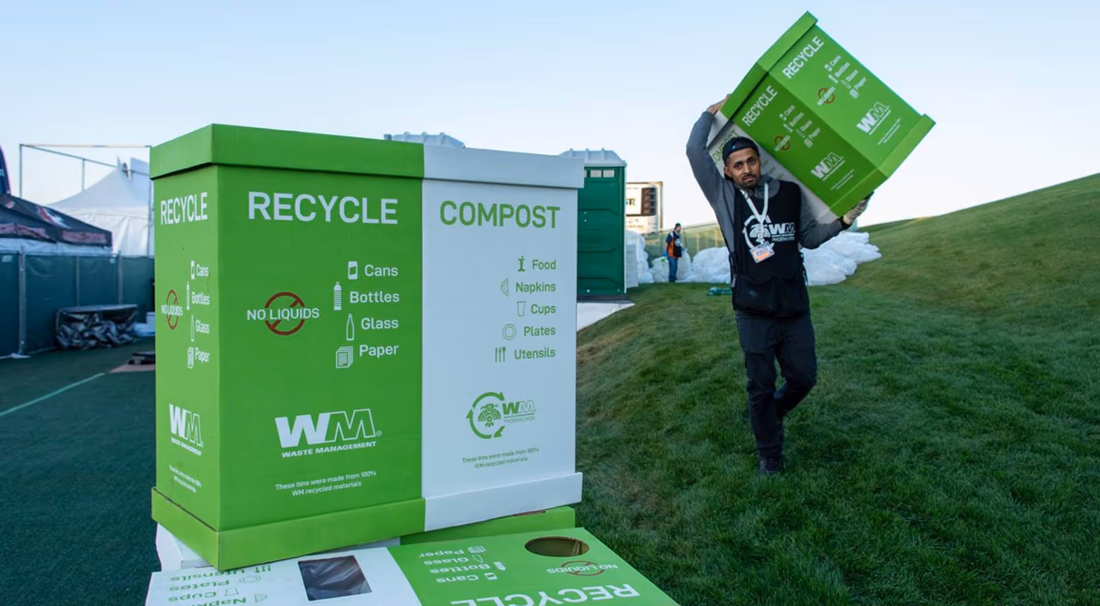 A man carrying a box of recyclable materials