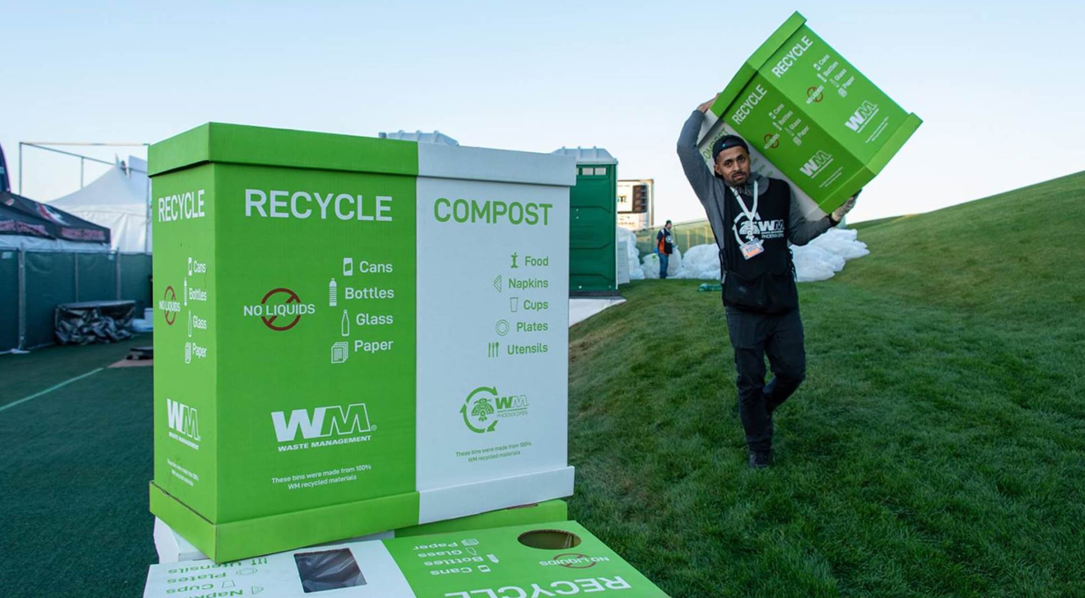 A man carrying a box of recyclable materials 