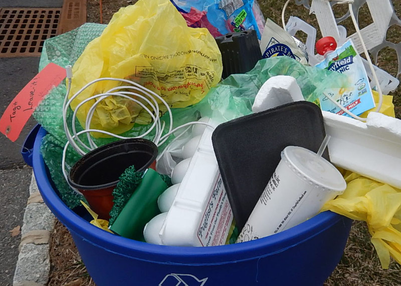 A bin full of different types of plastic mixed with other materials making it difficult for them to be recycled