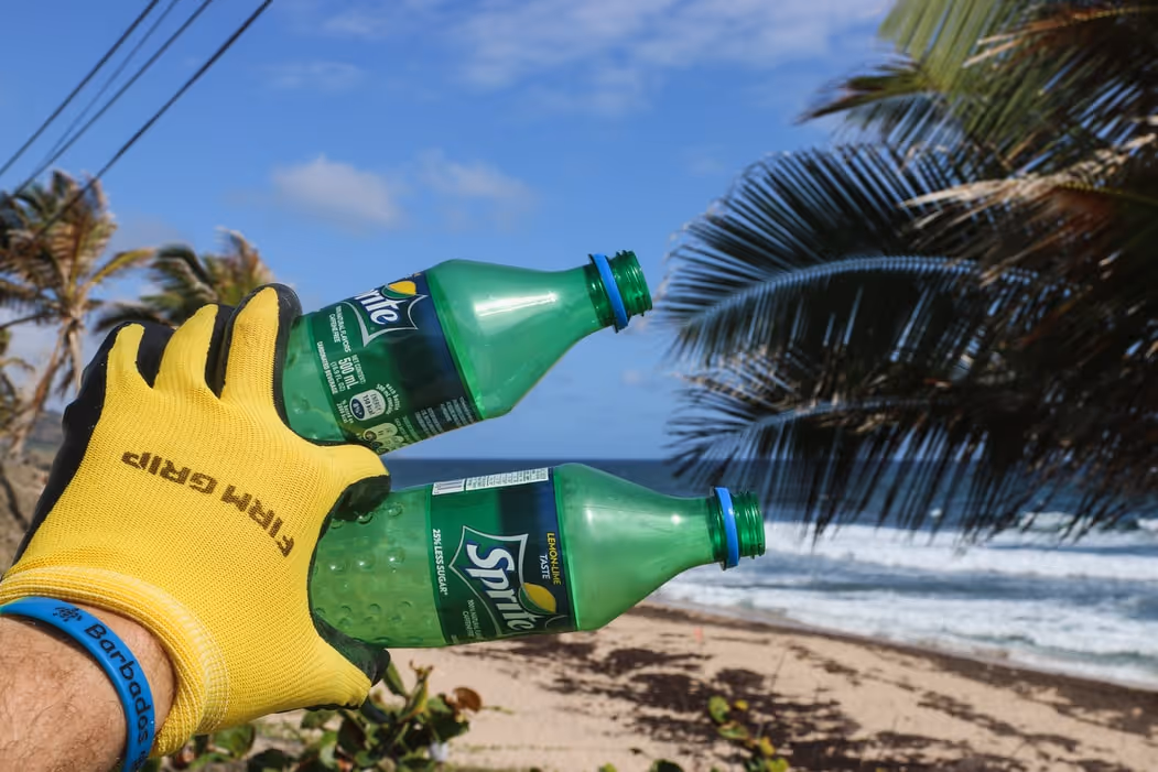 A pair of single use plastic bottles on a beach