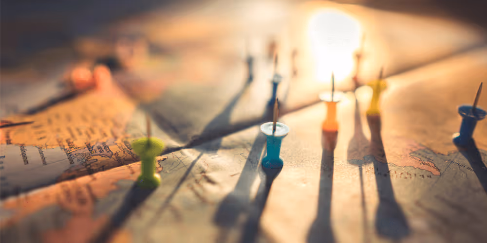 Thumbpins lying upside down on a world map