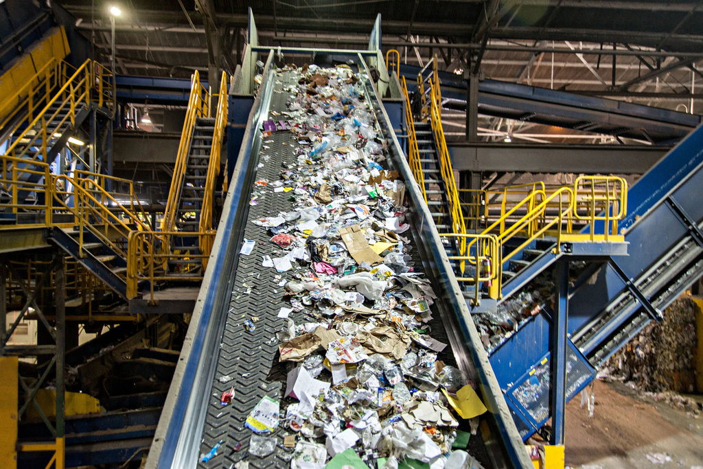 A recycling factory belt with different types of wastes on it on their way to be recycled