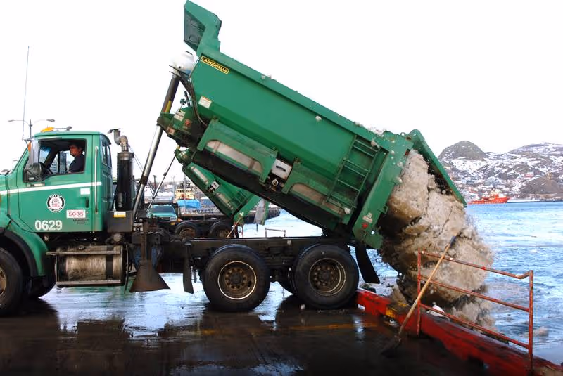 A truck dumping plastic waste directly in our oceans showing how plastics enter our oceans
