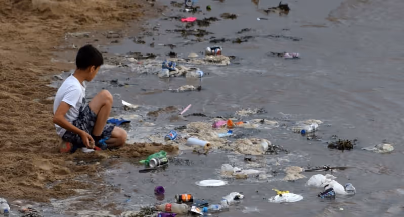 A beach with plastic waste littered all over it in UK