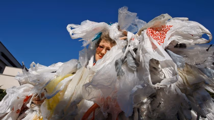 A woman covered in plastic bags