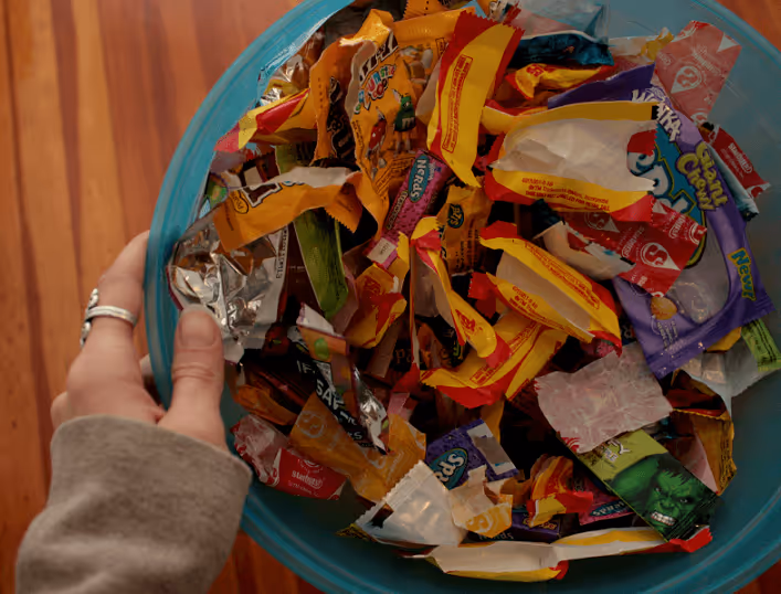 A bin full of plastic wrappers of chips and chocolates which are one of the major contributors to plastic pollution