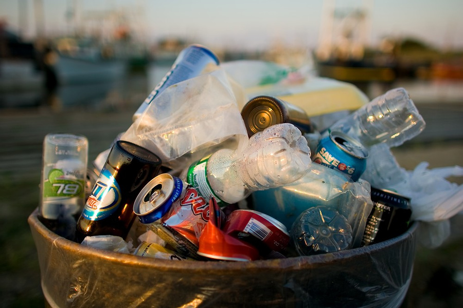 A trash can full of beverage cans and bottles which are one of the major contributors to plastic pollution