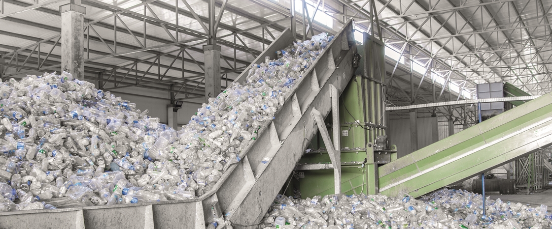 A recycling unit full of plastic bottles showing our plastic dependency
