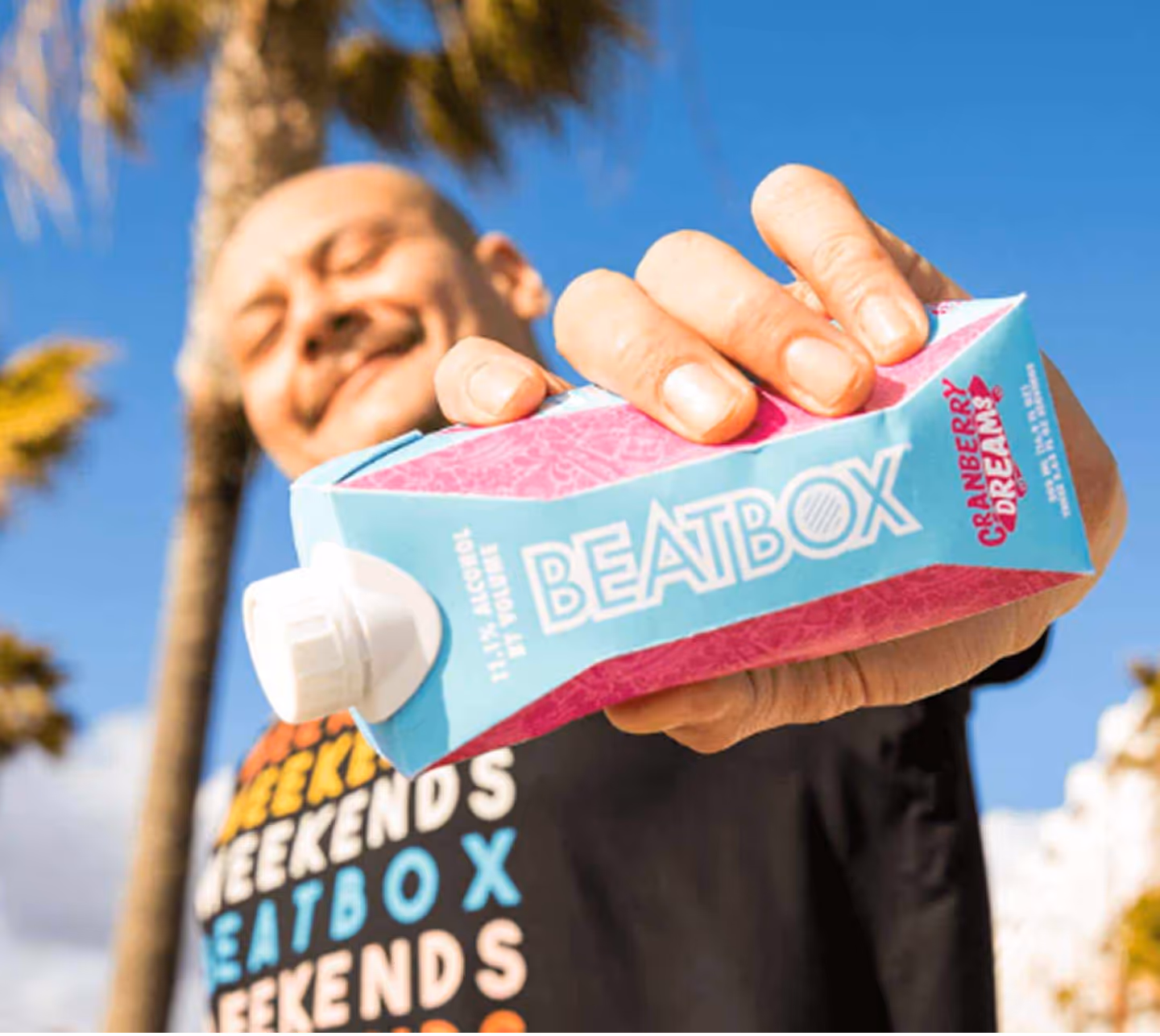 a man holding a carton of juice