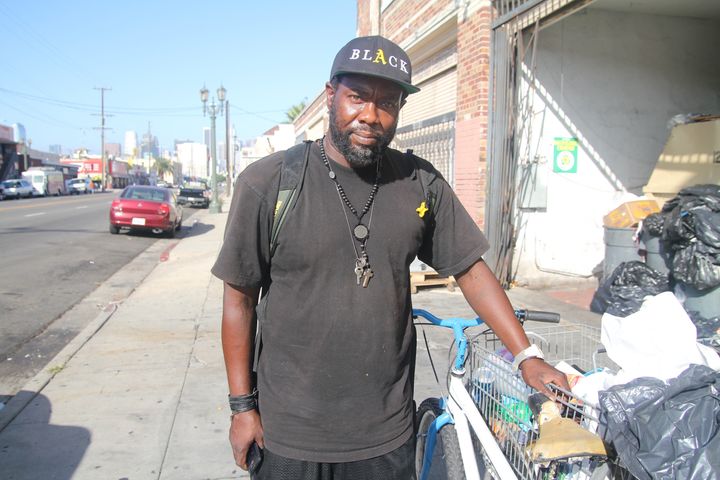 A man with a cart of plastic bags and plastic waste