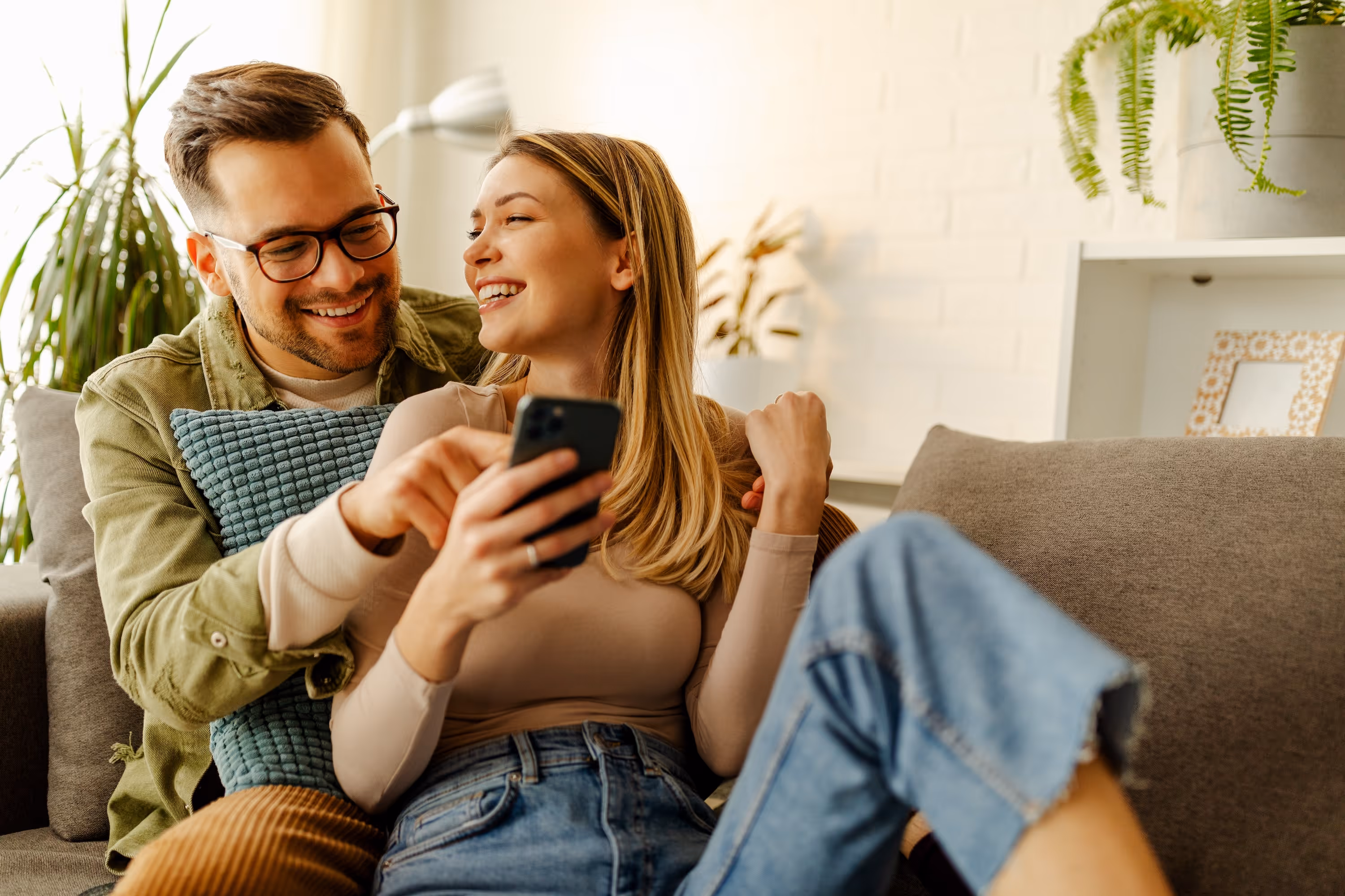 Couple Cuddling on Couch Stock Photo