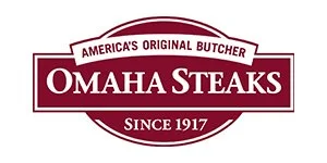 Omaha Steaks logo. The image is a black and white logo with the words "America's Original Butcher" inside a white ribbon at the top, "OMAHA STEAKS" in large bold letters in the center, and "Since 1917" in smaller text inside a banner at the bottom. The text is set against a black background with white outlines.