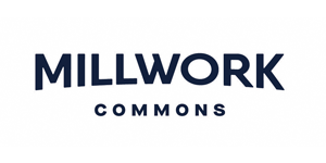 Logo with the words "MILLWORK COMMONS" in bold, uppercase letters. "MILLWORK" is written in a larger font above, while "COMMONS" appears in a smaller, spaced-out font below.