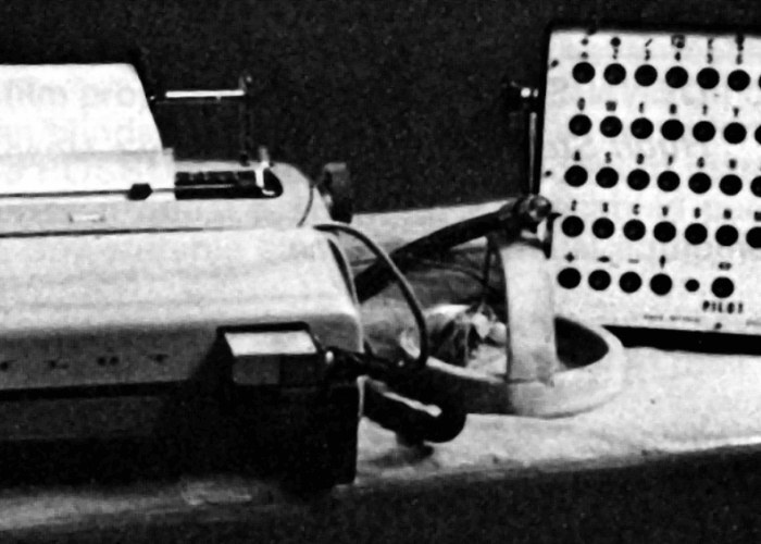 Photo in greyscale. Accessible technology sits on a table.