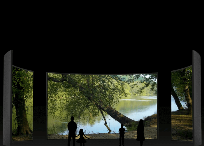 Black silhouettes of two adults and two children outside in front of a river, lots of trees.