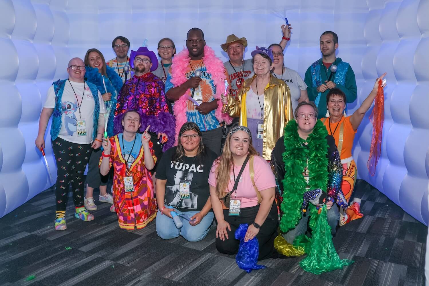 Fifteen people, one Black and the rest white, gather together for a group photo.