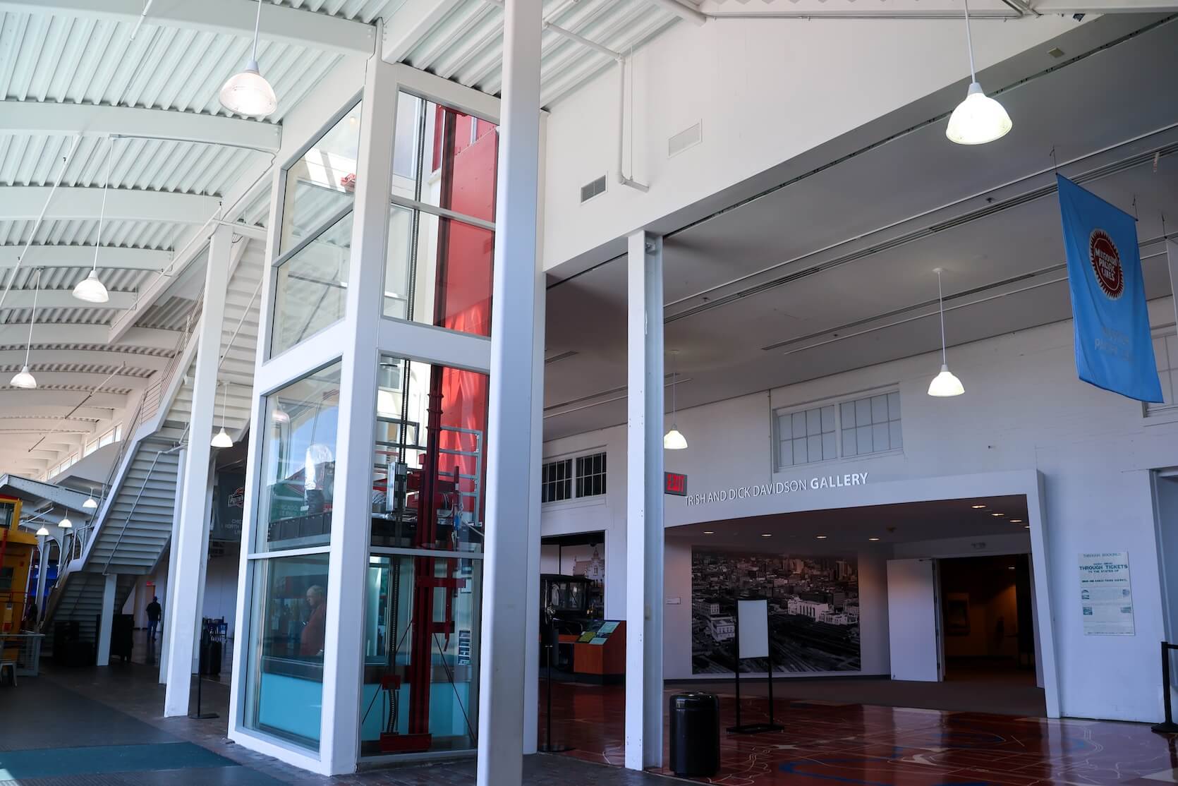 Inside the venue, focusing on the elevator with windows in the middle.