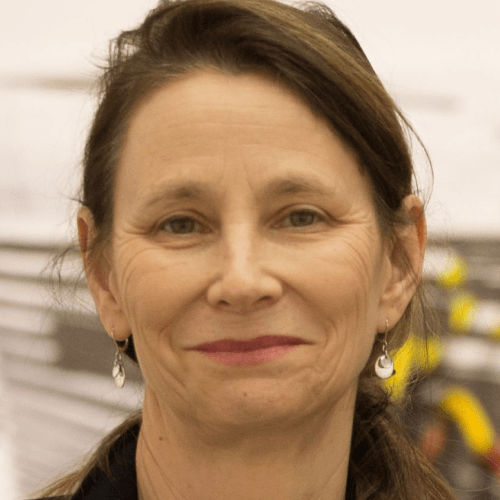 Susan is a white woman in her 60s, with straight dark brown shoulder-length hair.
