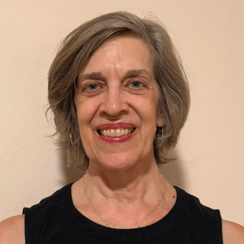 Eileen Thomas is a tall, white, middle aged woman with short brown and gray hair.