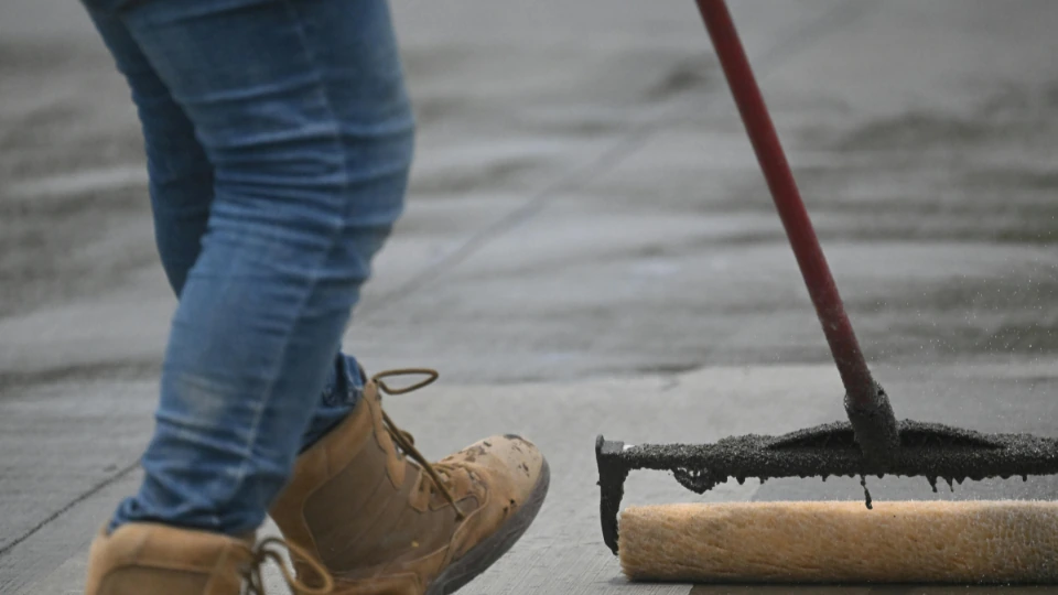 Driveway being sealed to protect against oil stains and moisture in Oxnard, California