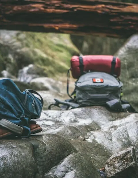 Hiking backpacks resting on top of rocks.