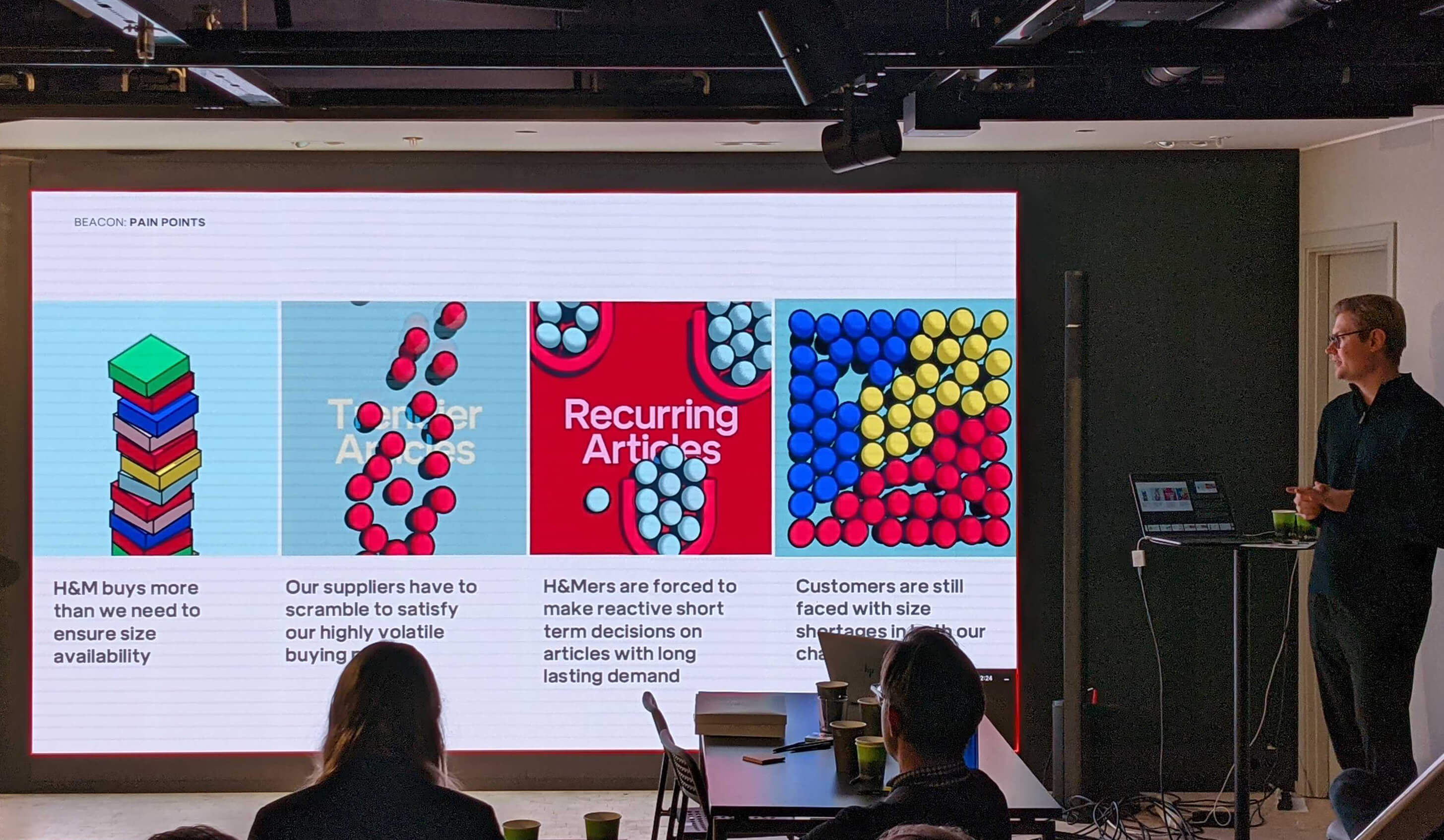 A person presents key points of Project Kigumi to a room of people