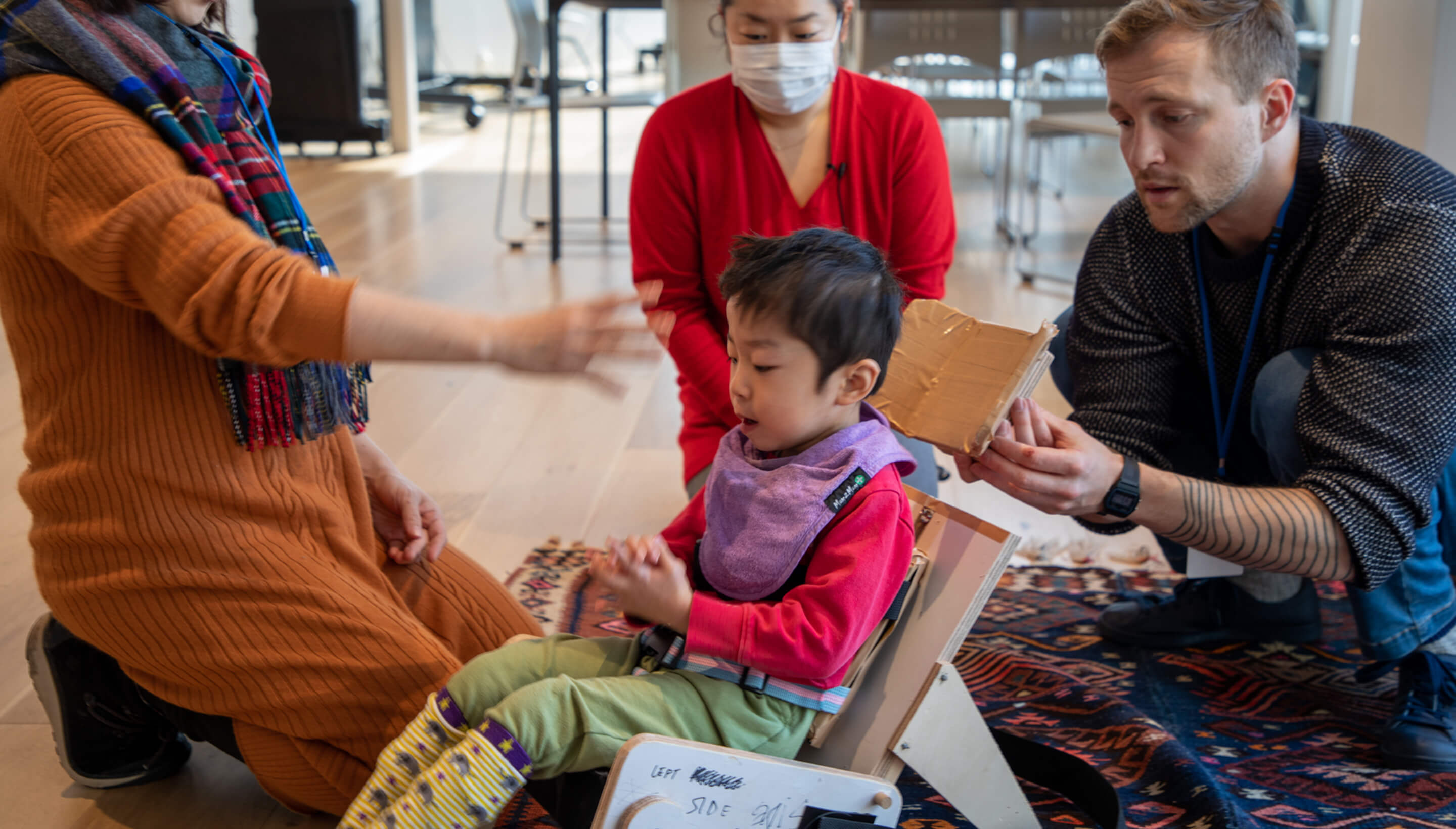 Child sitting in an IKOU chair prototype