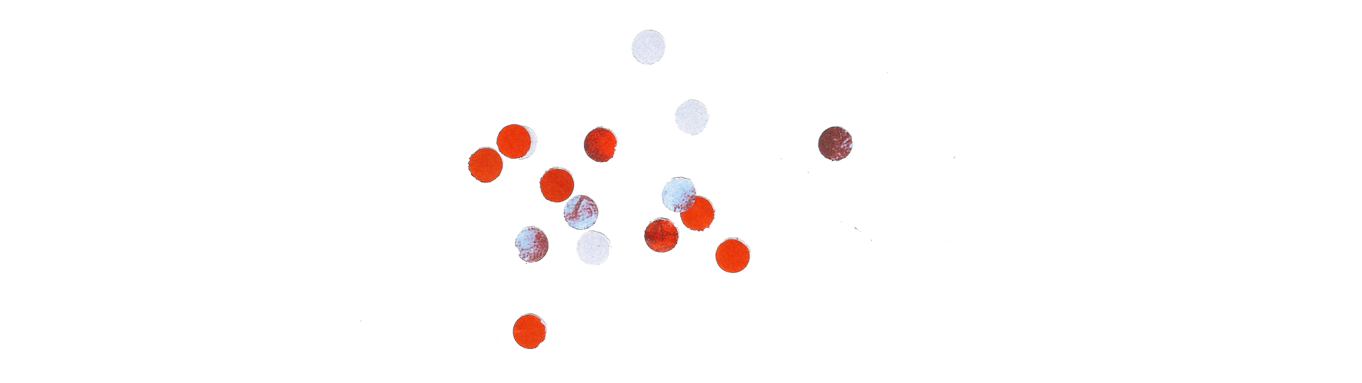 A series of small, scattered red and white circular dots placed on a white background. The dots are arranged in a seemingly random pattern, with varying shades of red and white, suggesting an abstract design or data visualization.