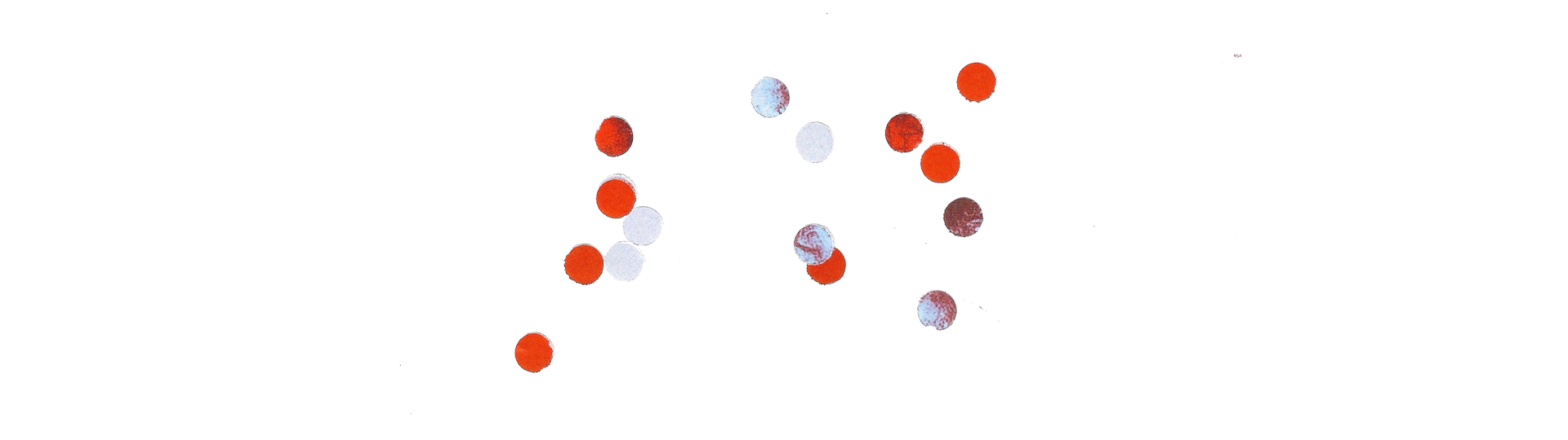 A series of small, scattered red and white circular dots placed on a white background. The dots are arranged in a seemingly random pattern, with varying shades of red and white, suggesting an abstract design or data visualization.