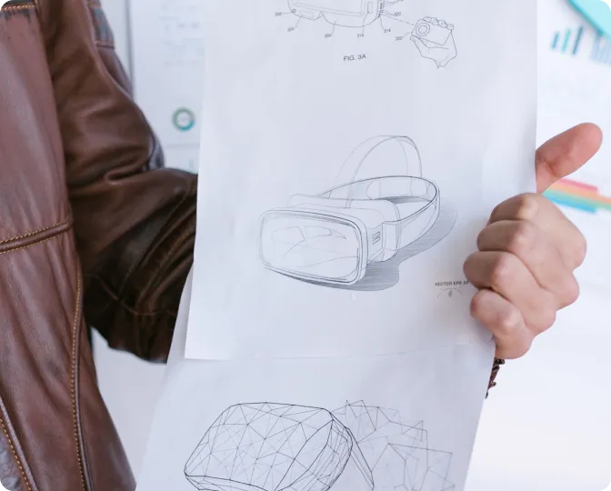 Hand-drawn concept sketches of a VR headset on paper