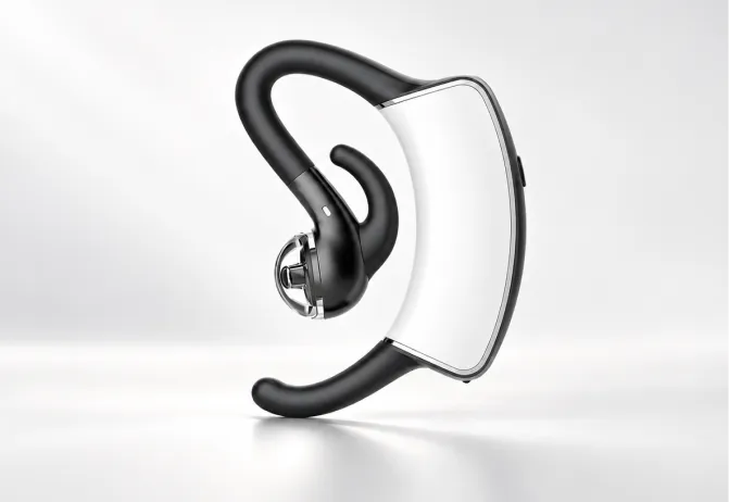 Close-up of a white and black bone-conduction earbud with ear hook